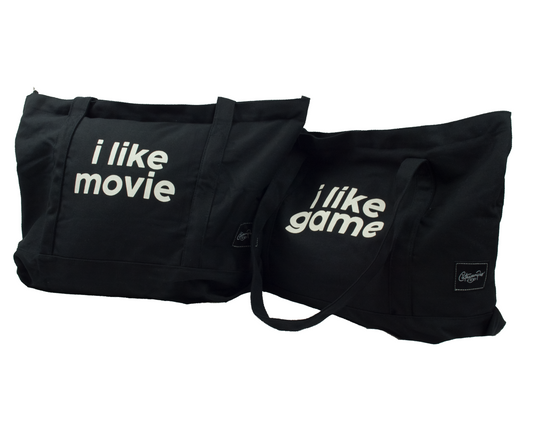 Two black tote bags with white text that reads "i like movie" and "i like game" respectively